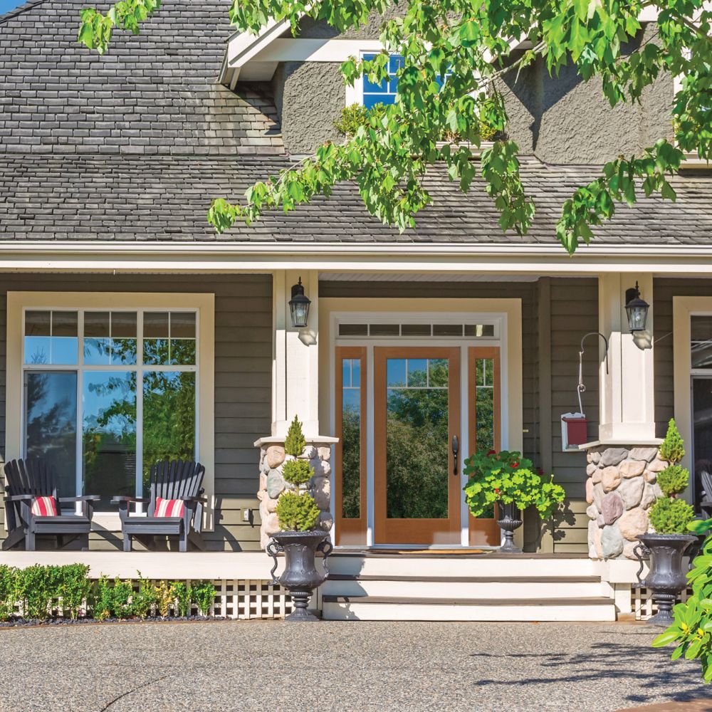Beautiful house with picture windows and front door with lots of glass.
