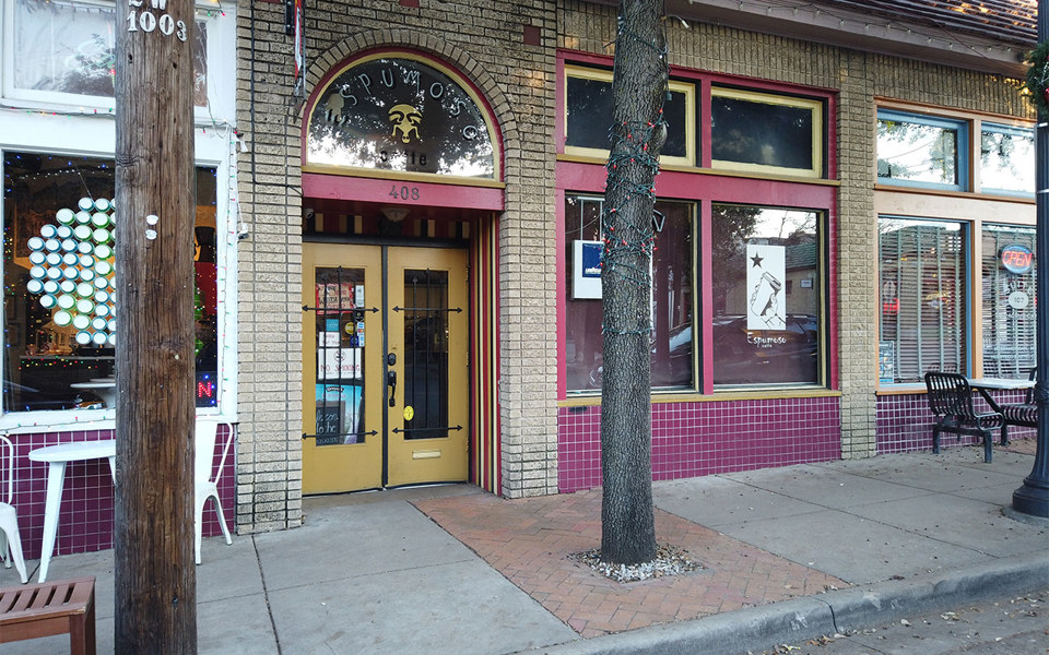 Yellow door entrance to Espumoso Cafe in Bishop Arts District.