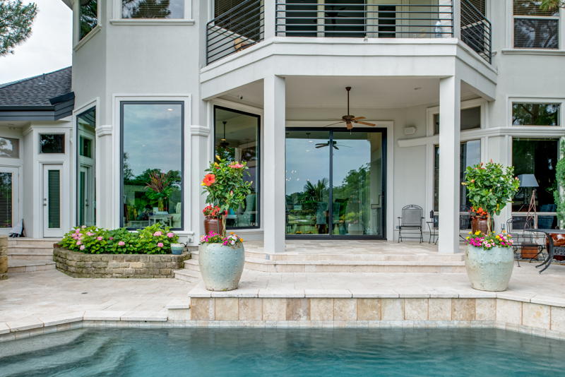 exterior view of pool and sliding patio garden and sliding glass door