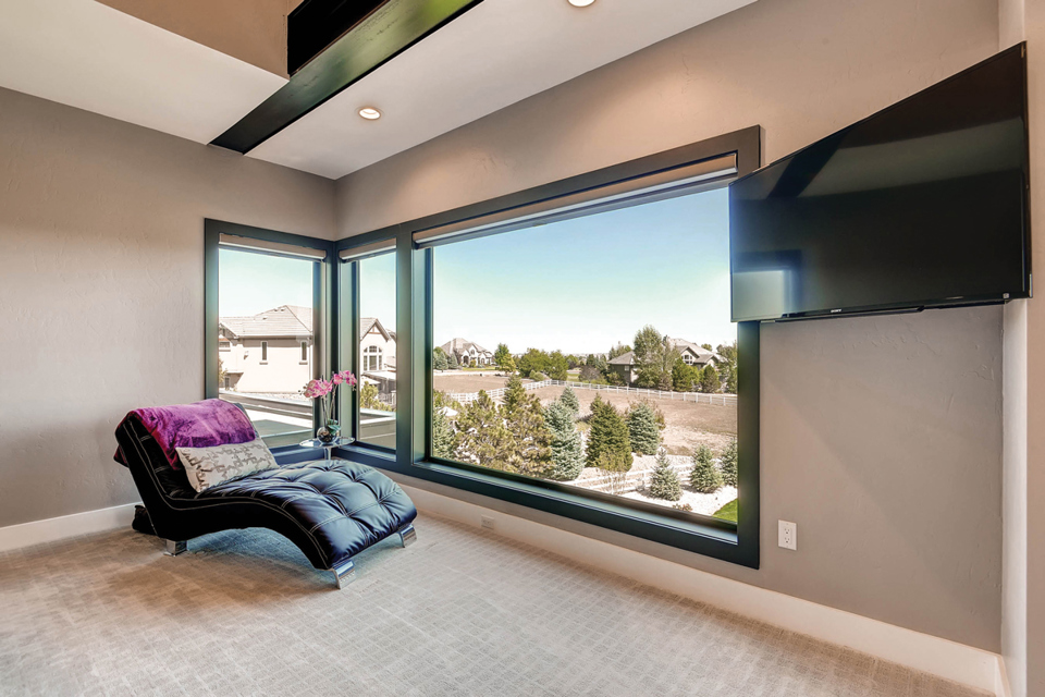 Example of fiberglass windows. The windows featured in this image are from Milgard's Ultra. In this image they are large without grids and in a black interior finish.