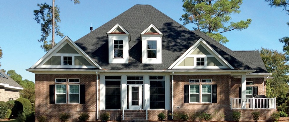 Large home with a shadow falling across the front facade.
