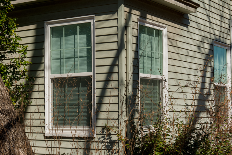 brennan-traditions-green-home-with-white-trim