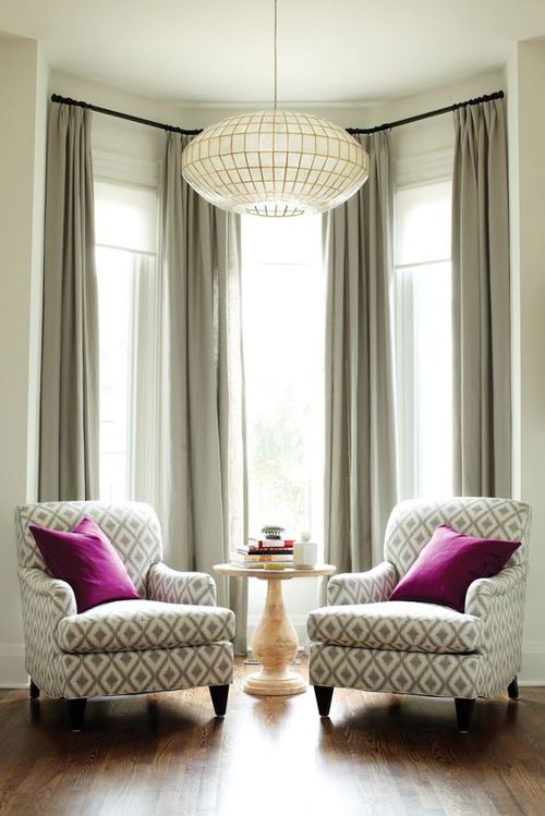 Classic reading nook with diamond patterned arm chairs and bright accent pillows.