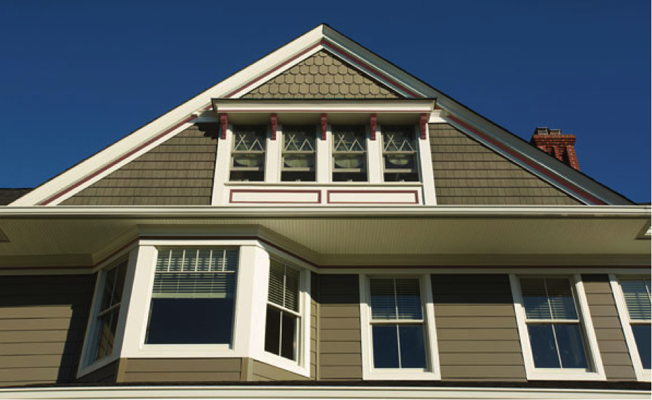 House with three styles of siding: lap siding, straight-edge shingle siding, and scallop siding.
