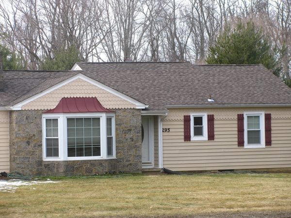 Example of scallop shingles oddly installed on simple ranch style house.