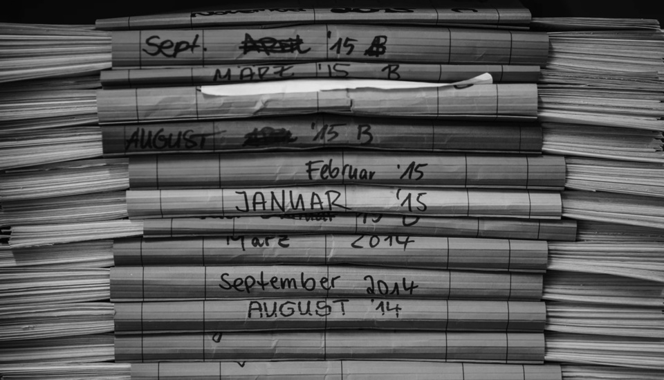 A stack of papers dated by month and year.