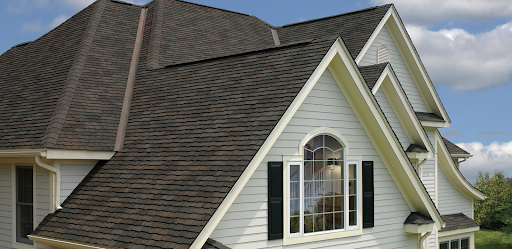 White vinyl-clad home with wood-shake inspired asphalt shingles.