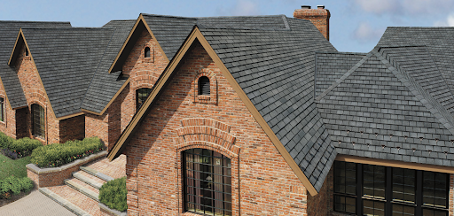 Slateline fiberglass asphalt shingles atop a red brick home.