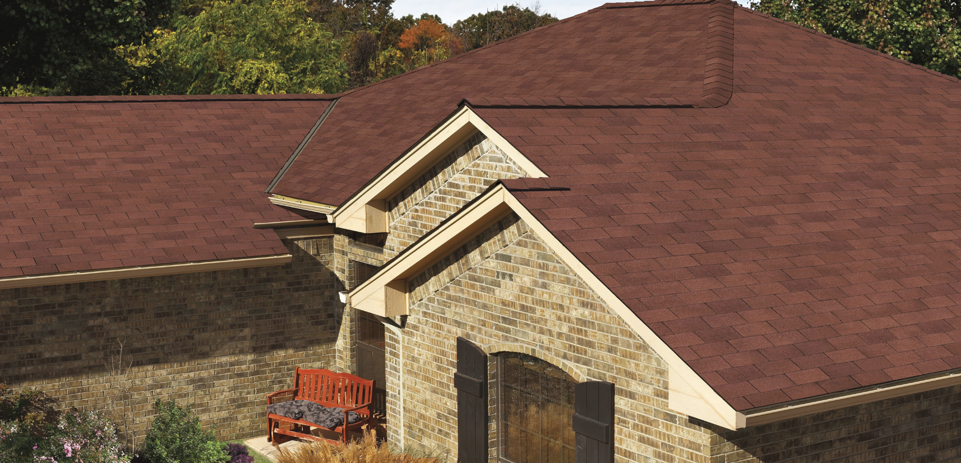 GAF Royal Sovereign asphalt shingles atop a light colored brick home.